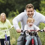 happy-family-with-bikes-forest-road_23-2148225787